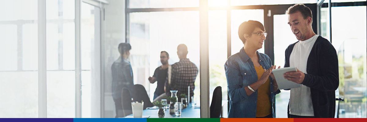 Staff having a meeting in open plan office