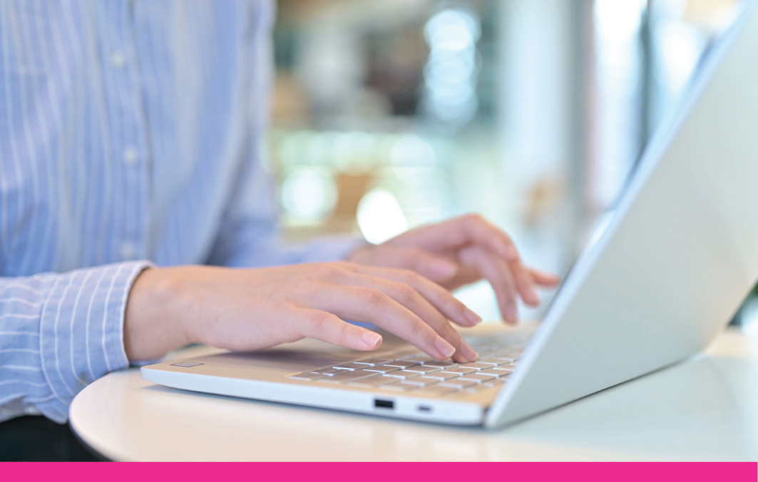 Image of person typing into a laptop