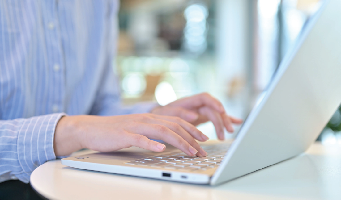 Person completing online application at laptop