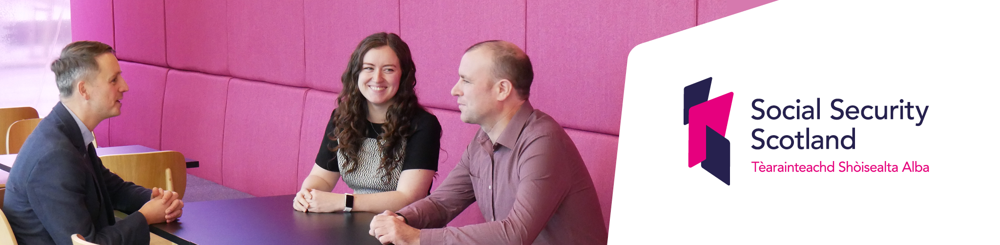 Image of staff talking with Social Security Scotland Logo